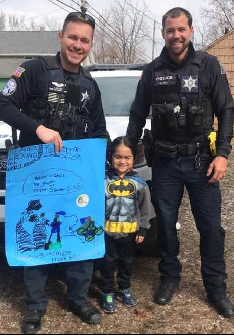 Officer Hus and Hill receive poster from young man