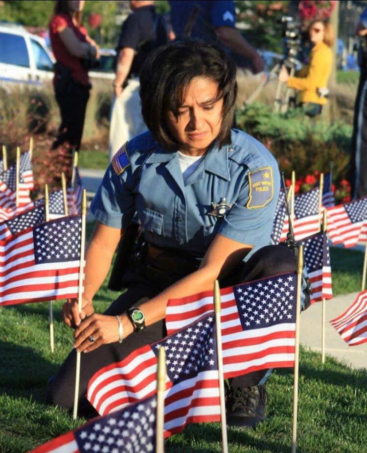 Raquel placing flags on lawn